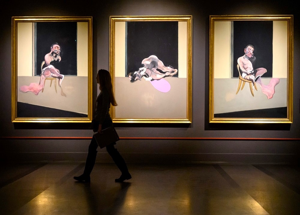 Francis Bacon — gold-framed painting held by gloved handlers